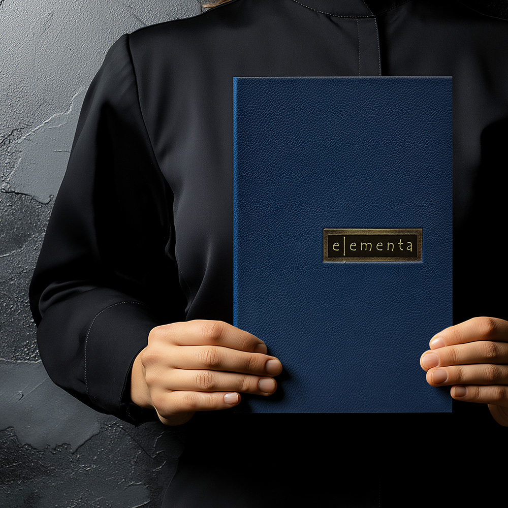 Elementa authentic leather dyed blue with custom layered etched metal window insert and metallic gold lining with removable added panel page